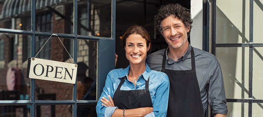 blog-business-interruption-insurance-happy-couple-standing-outside-of-business.jpeg