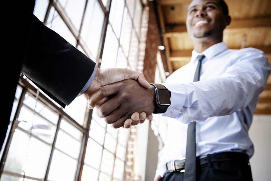 About Our Agency - Businessmen Shaking Hands at Emerge Insurance Agency After a Successful Business Meeting